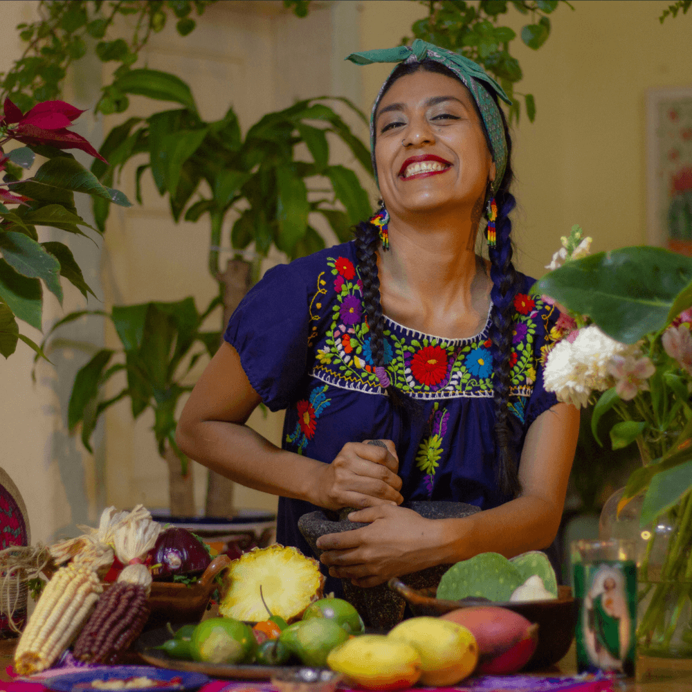 Jazz, a Mexican woman with long braided pigtails making salsa in the kitchen