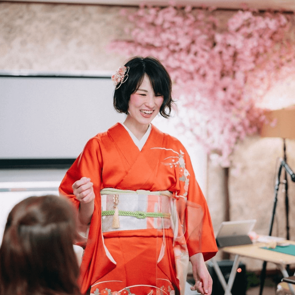 Manami Watanbe in traditional Japanese attire teaching about Japanese culture and origami
